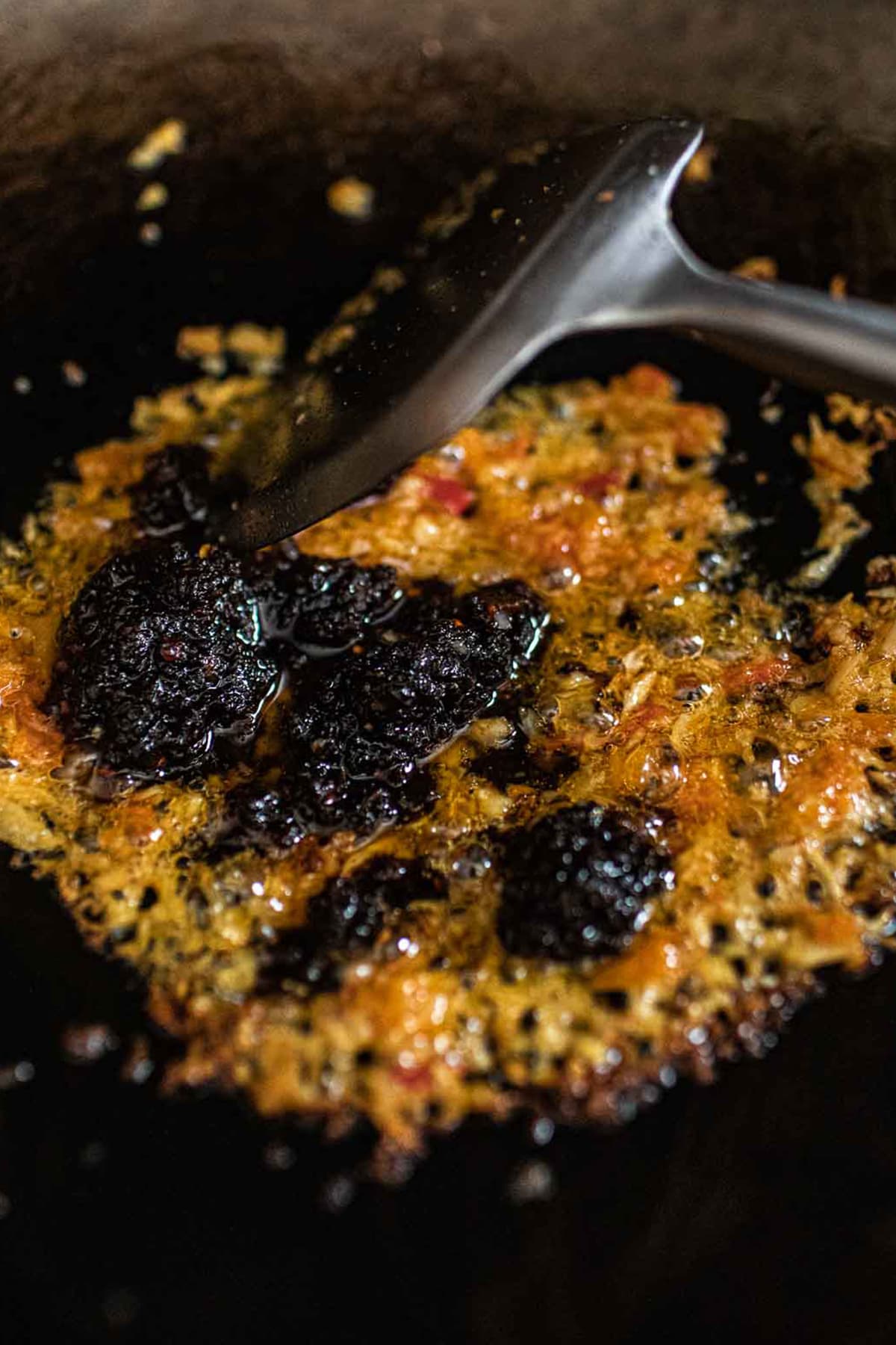 Chili sauce frying in a wok with chili paste. 