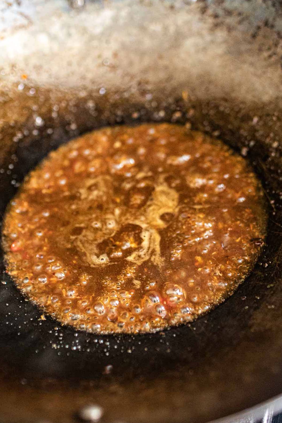 Chili sauce frying in a wok.