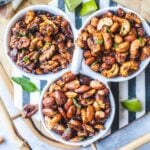 Thai Tom yum roasted nuts in 3 white bowls on a tray.