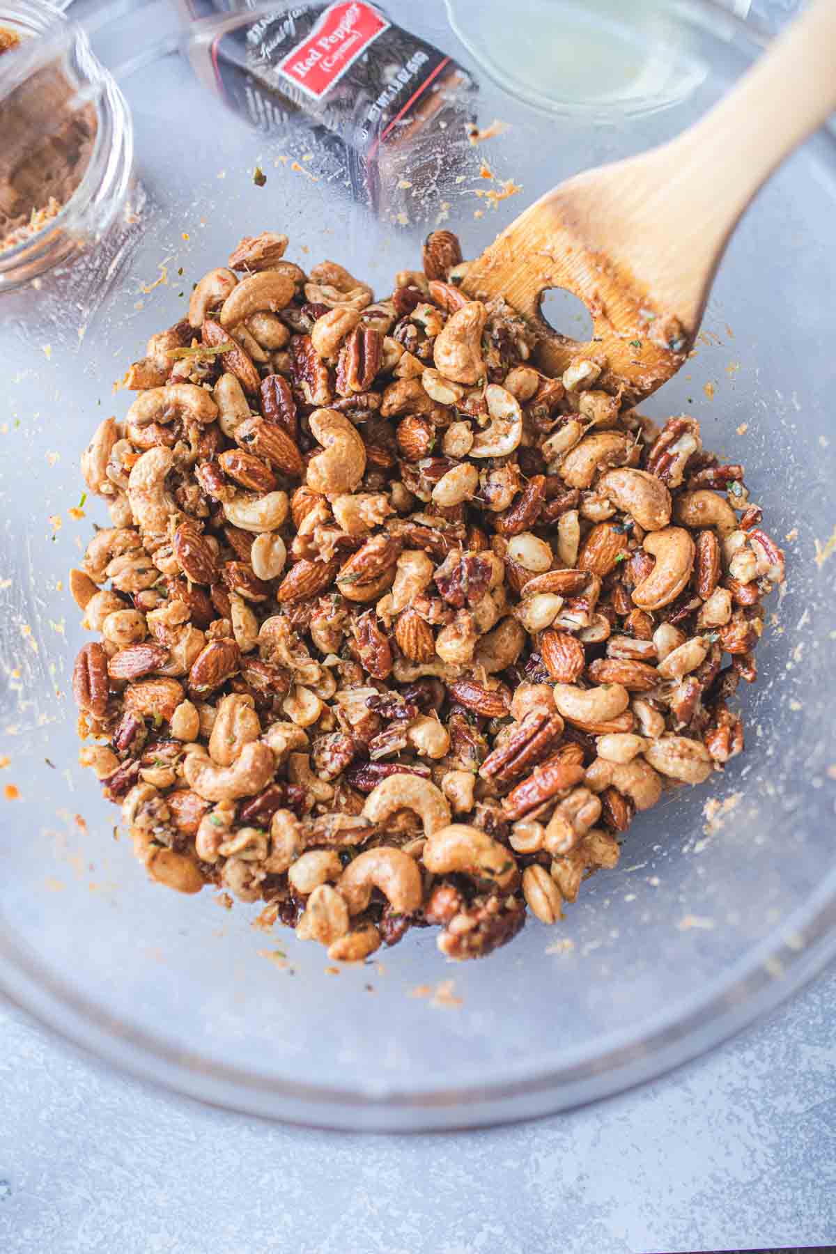 Tom yum roasted mixed nuts in a glass bowl.