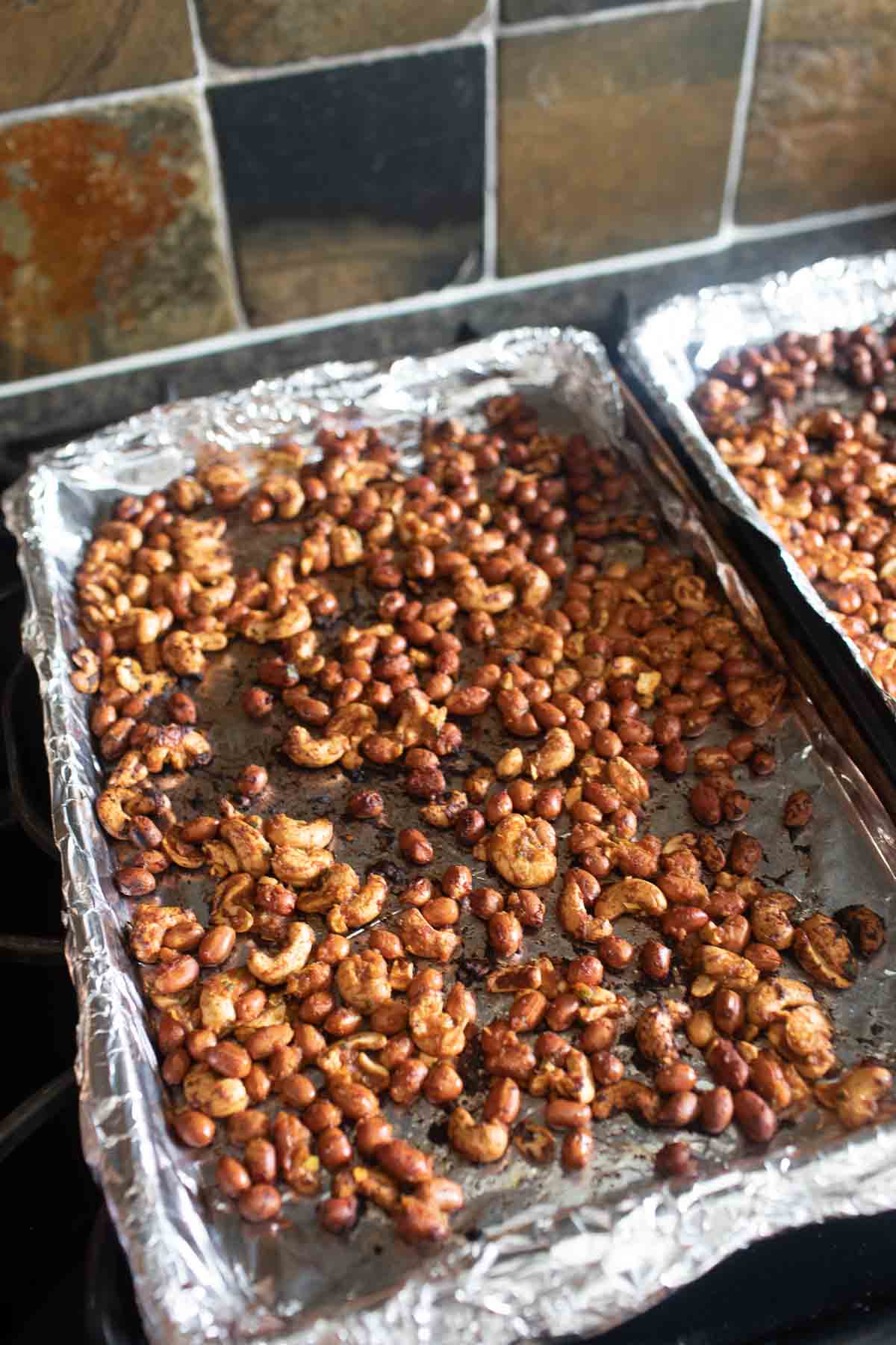 Tom yum roasted peanuts on a baking sheet.