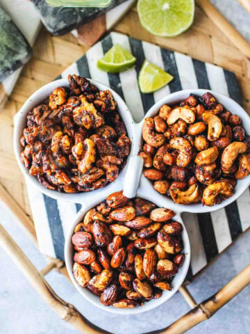 Tom yum roasted nuts in 3 separate bowls on a tray.