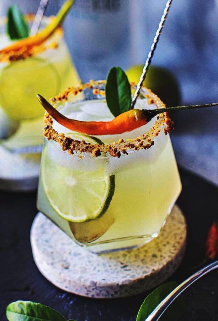 2 glasses of tom yum cocktails on a tray.