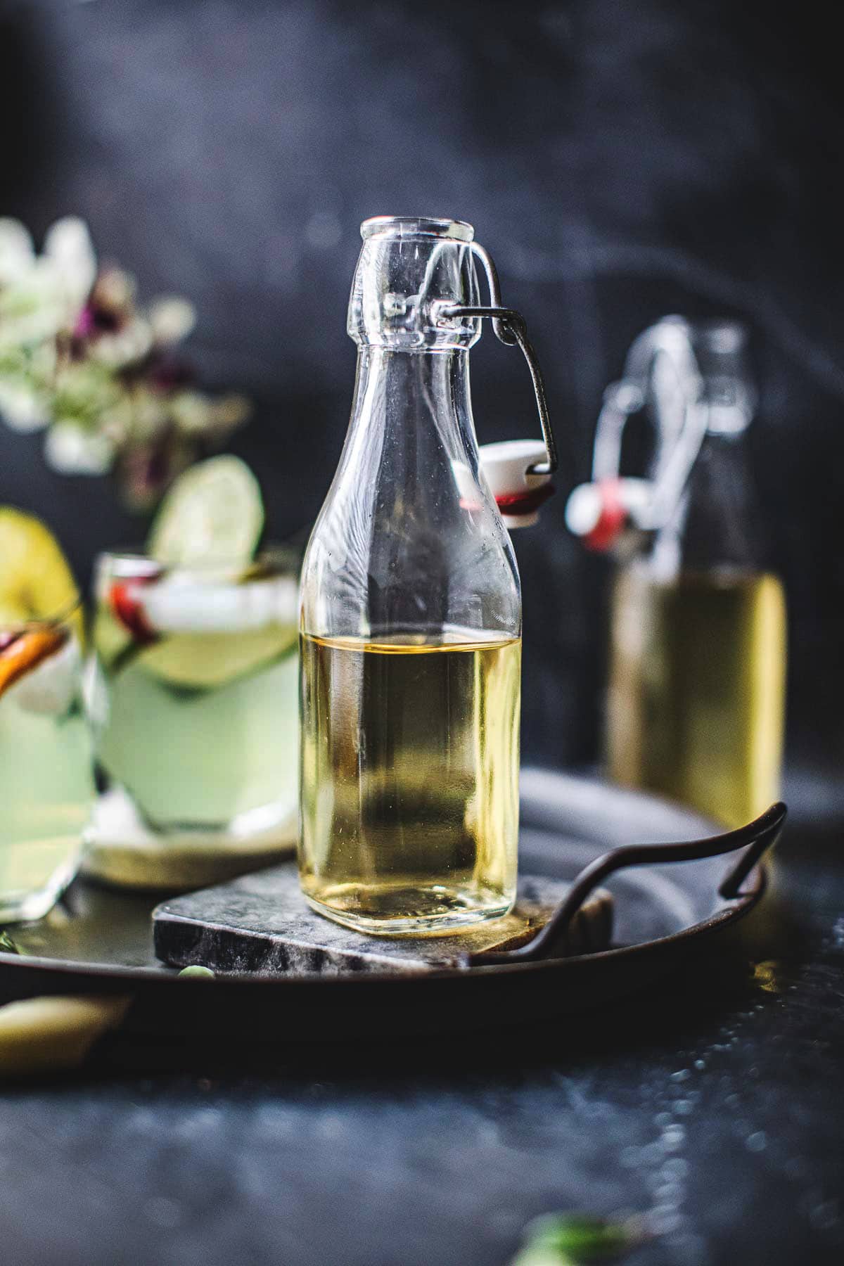 Simple syrup in a clear glass bottle on the table. 