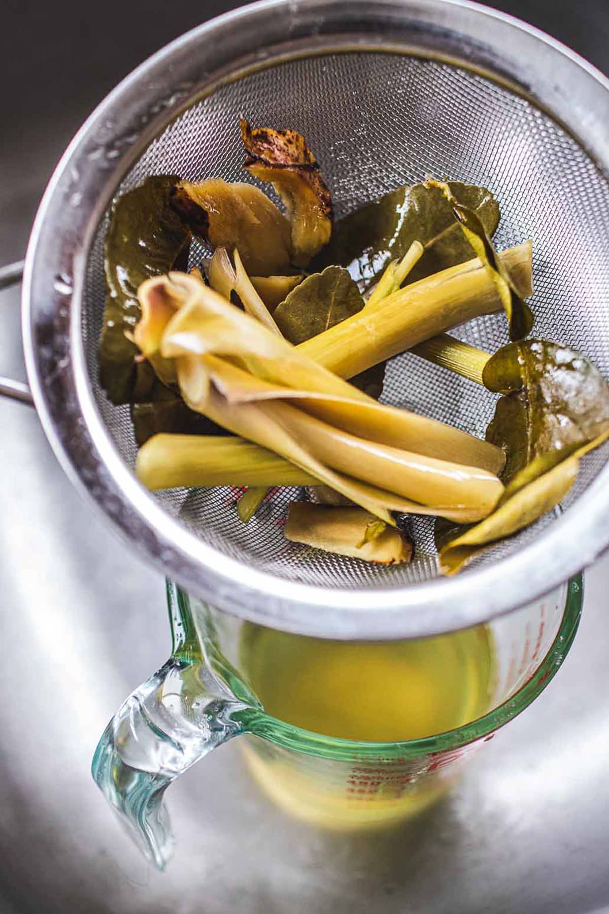 Tom Yum Herbs in a strainer in the sink.