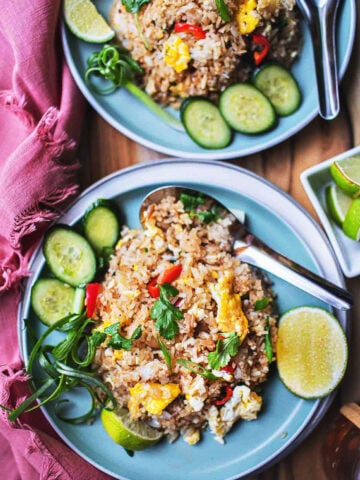 Thai Khao Pad on 2 plates with garnishes.