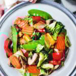 Pad Pak Room Mit Thai mixed vegetable stir fry on a white platter.