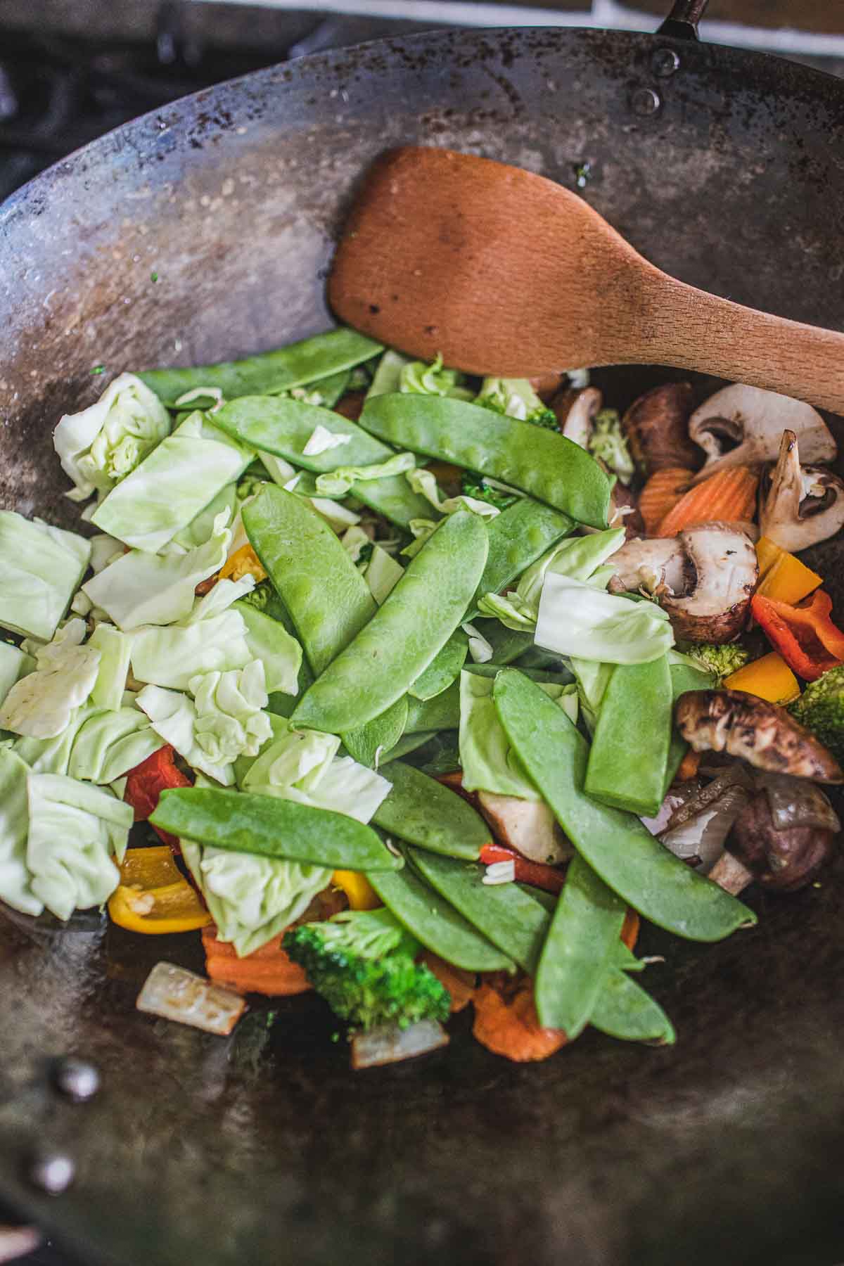 Vegetables pieces in a wok for making Pad Pad Room Mit stir fry.
