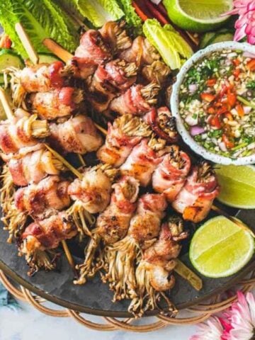 bacon wrapped enoki mushrooms on skewers.