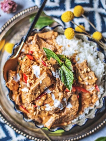 Panang curry in a platter with a spoon.