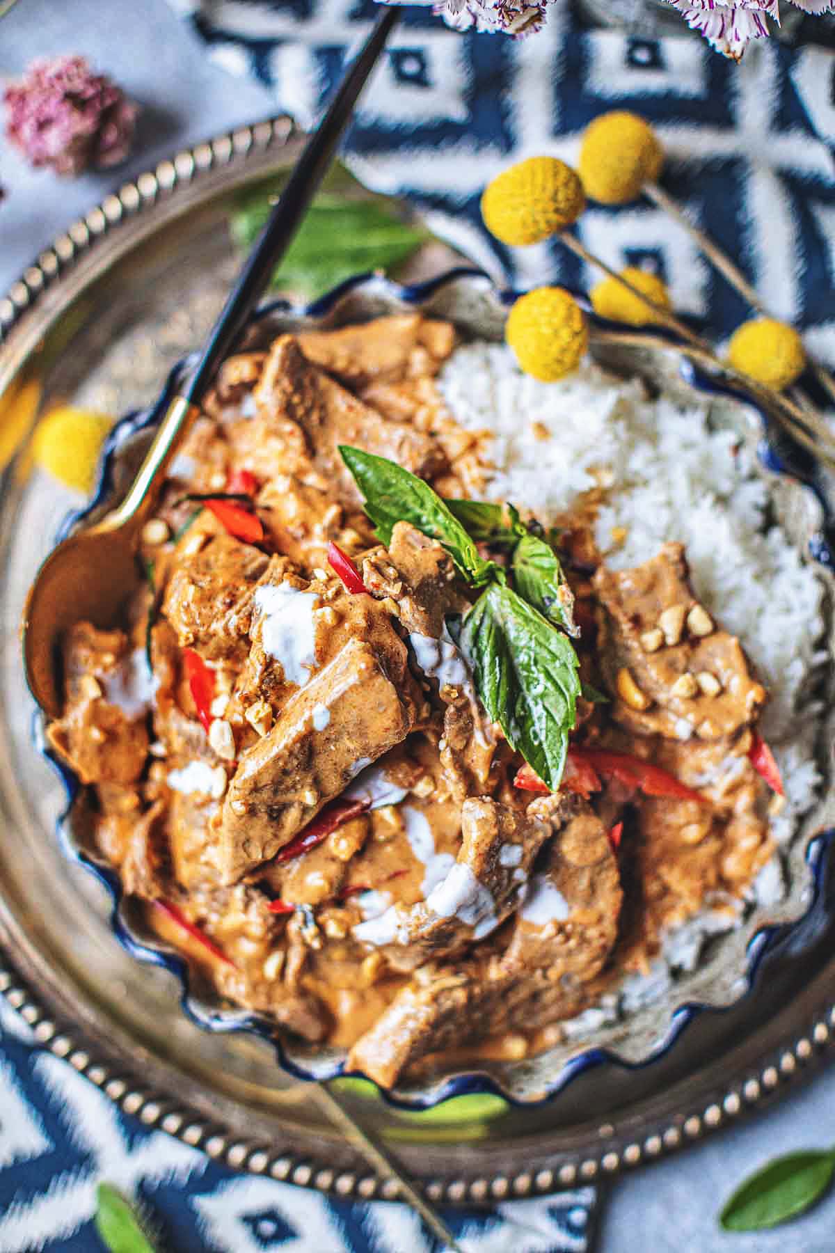 Panang curry in a platter with a spoon.