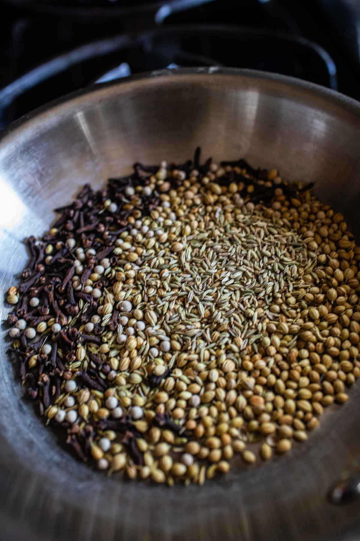 Spices toasted in a pan on the stove. 