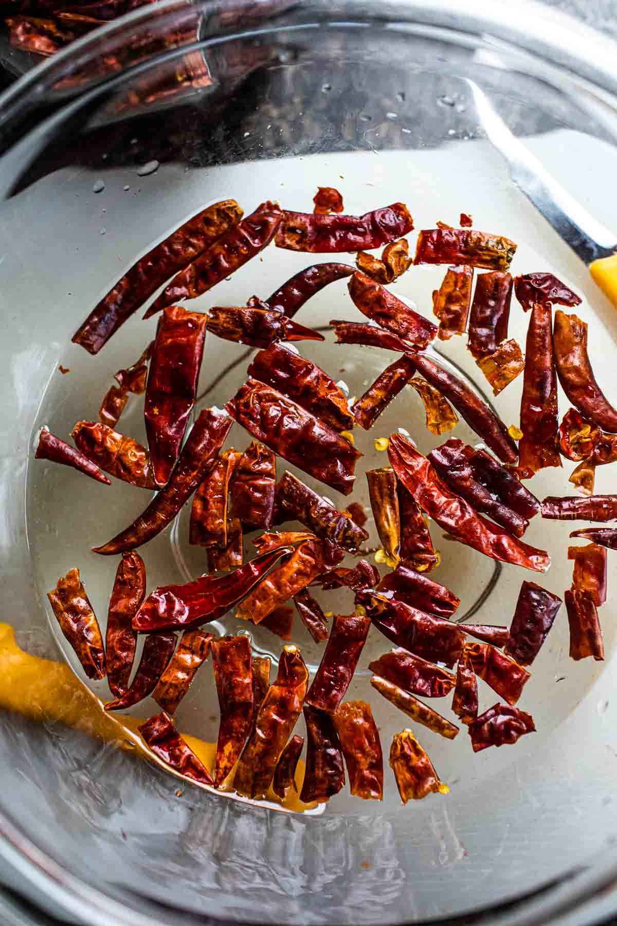 Red chilies soaking in water in a bow.  