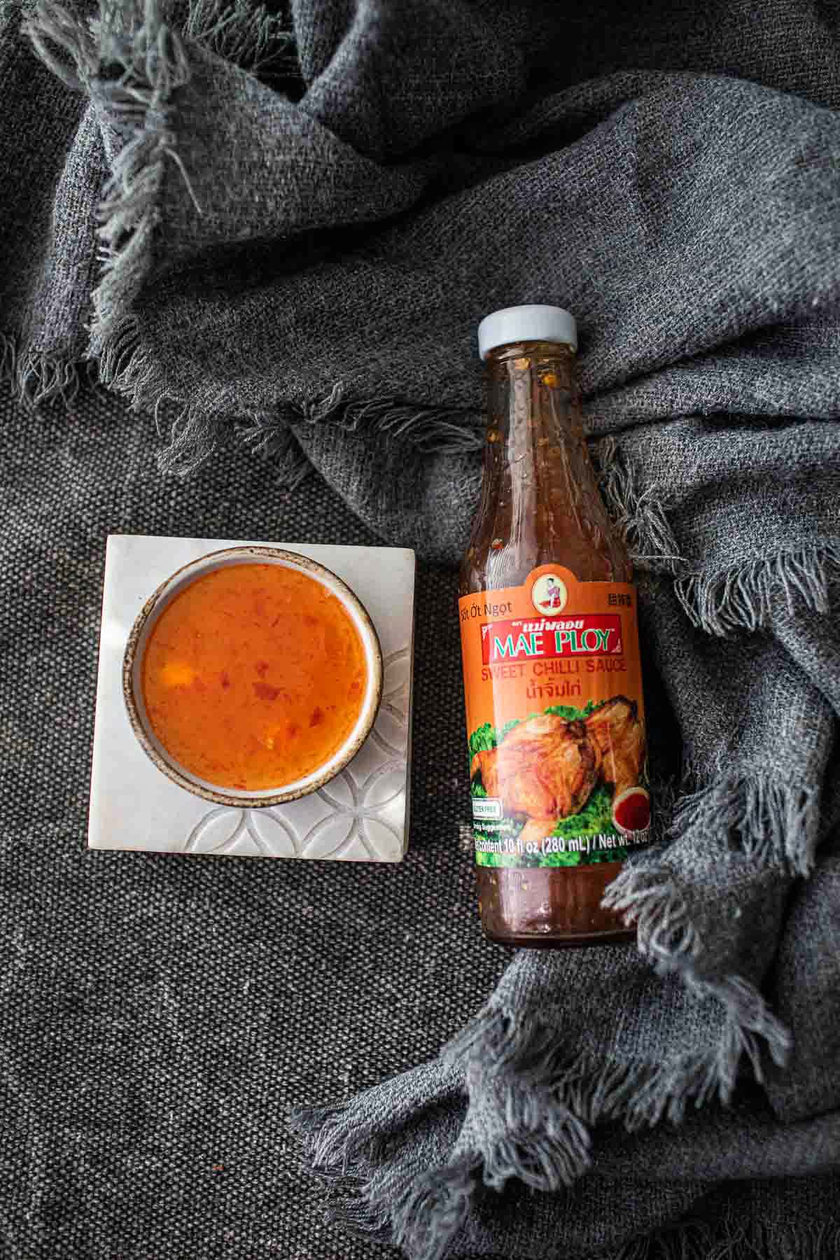 Thai sweet chili sauce in a bottle and in a small bowl.