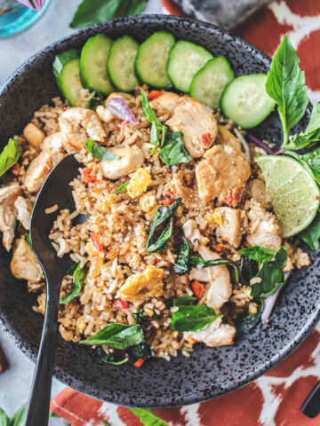 Thai basil fried rice on a plate with a spoon.