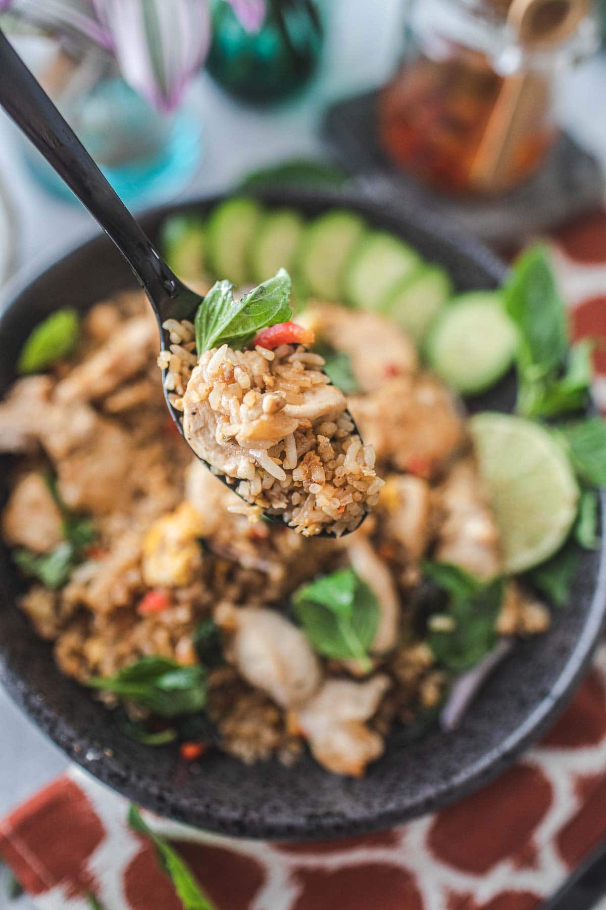 Spoon lifting thai basil fried rice.