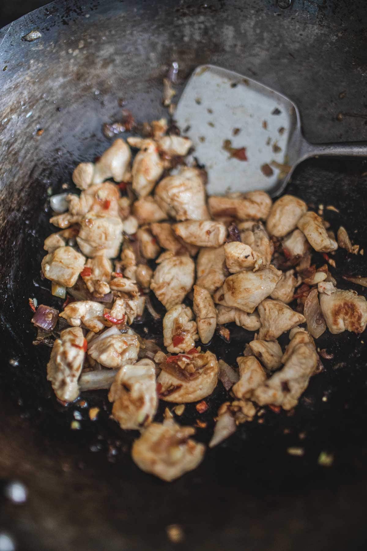 Frying chicken in a wok.