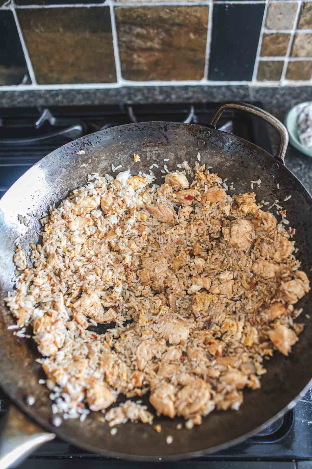 Thai chicken basil fried rice in a wok.