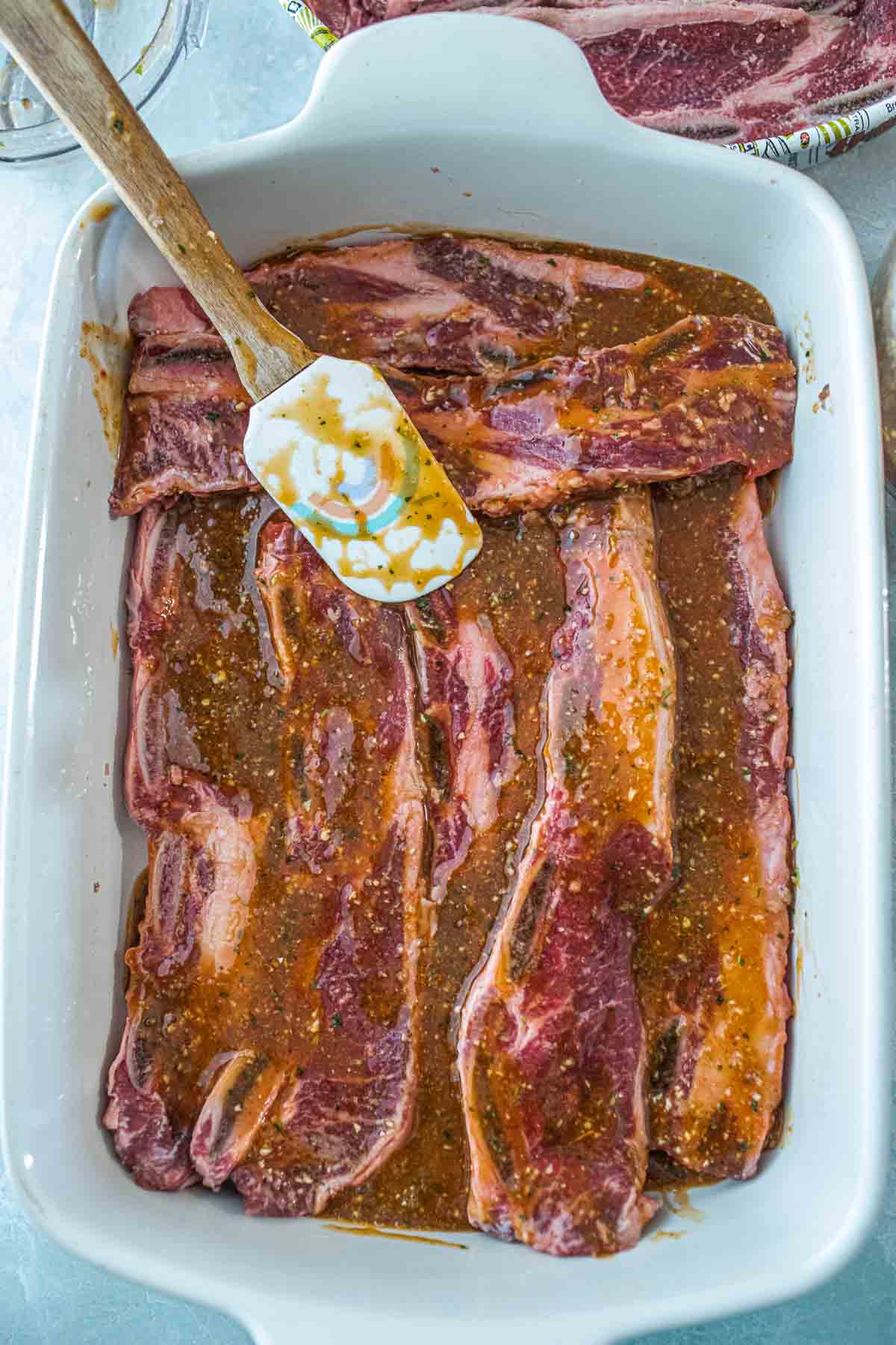 Asian Flanken beef ribs in a marinade in a pan.