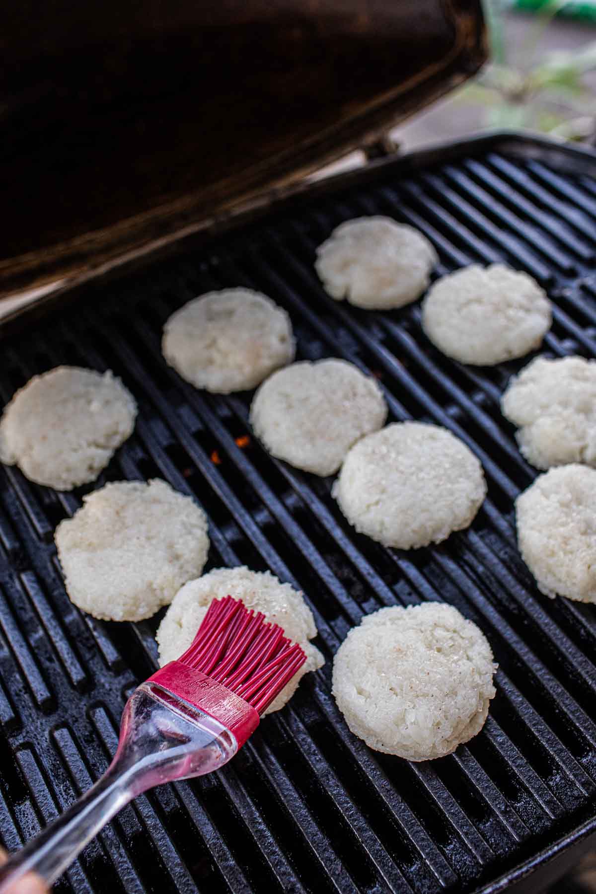 Lao Grilled sticky rice patties on the grill. 