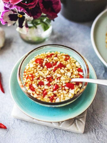 Prik Nam Pla with a spoon in a bowl.