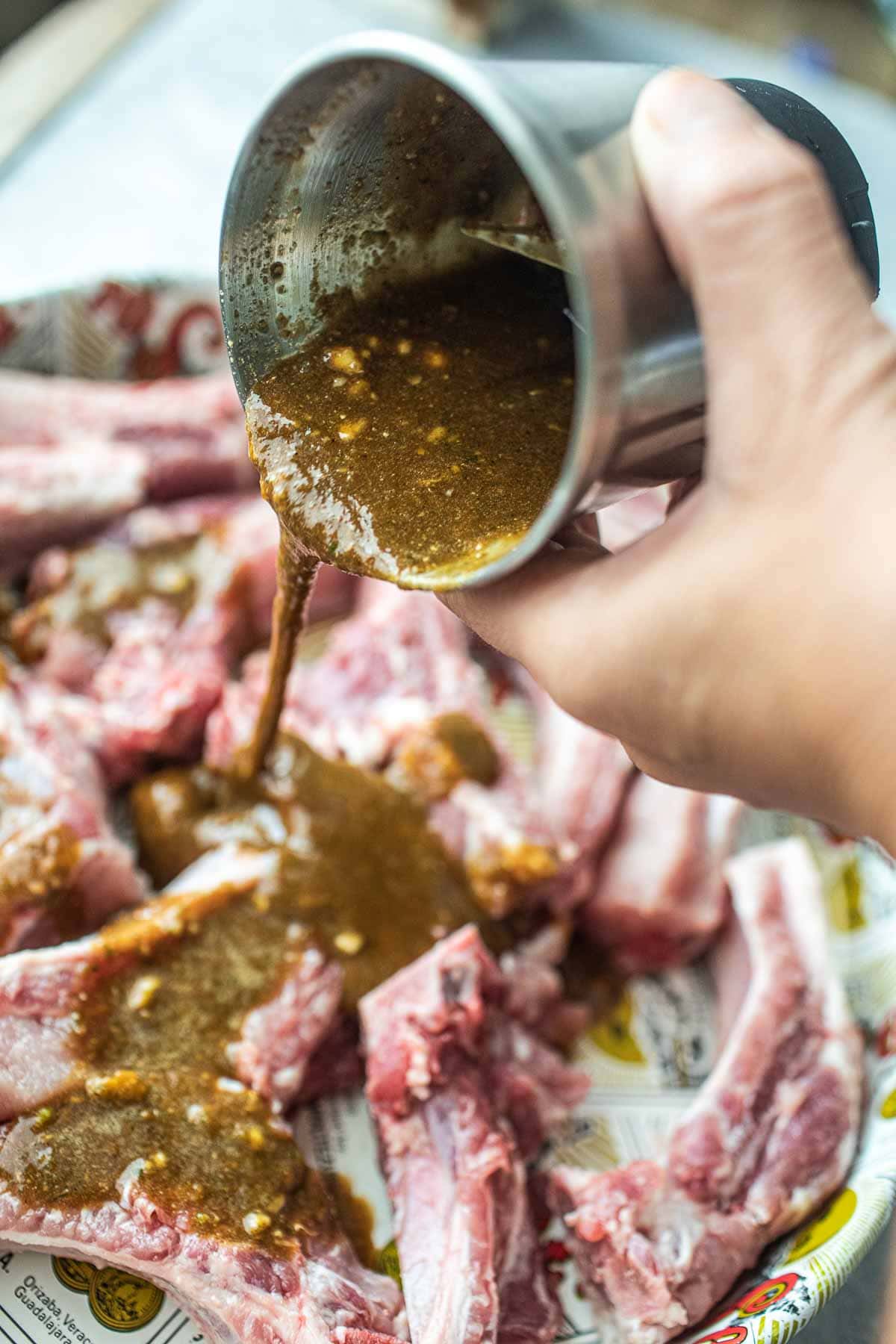 Thai pork ribs sauce pouring over pork ribs.