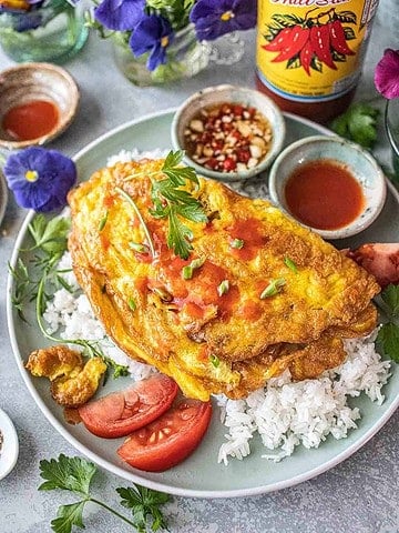 Thai style omelette with spicy dipping sauces on the side.