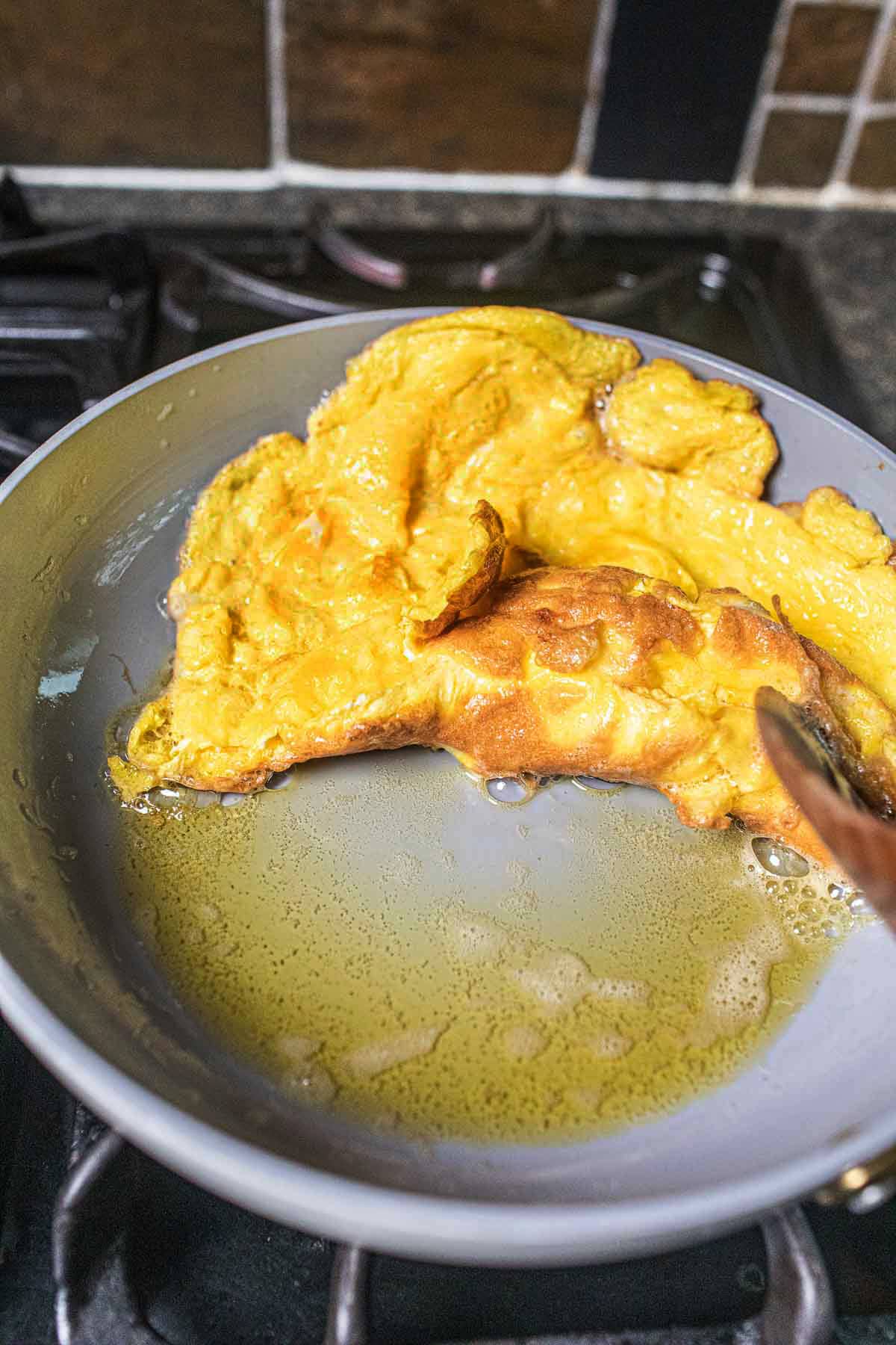 Thai omelette in a pan.