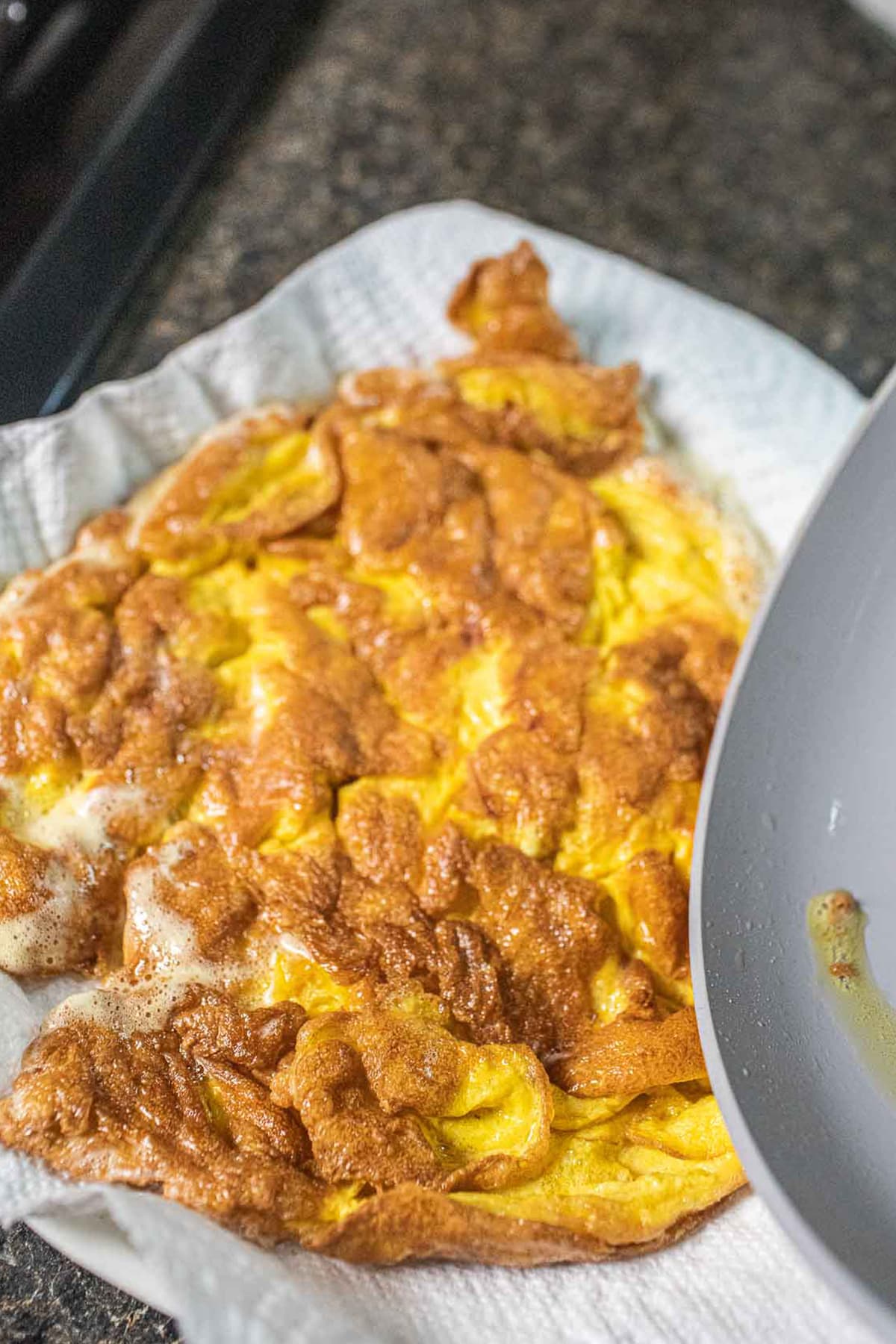 Crispy omelette on plate with paper towel.