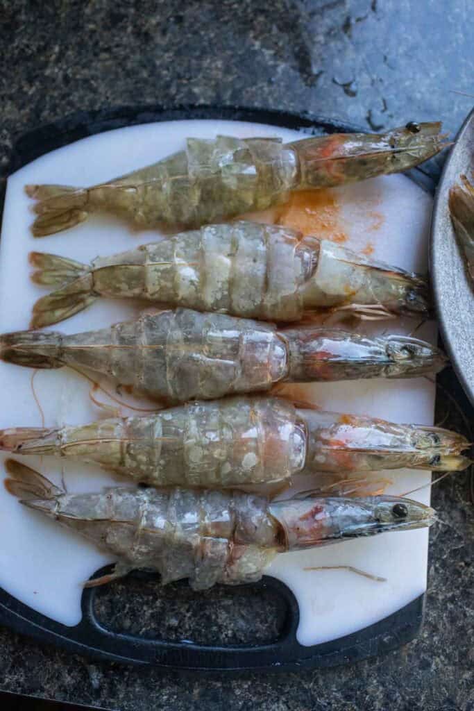 Butterfly shrimp on a cutting board. 