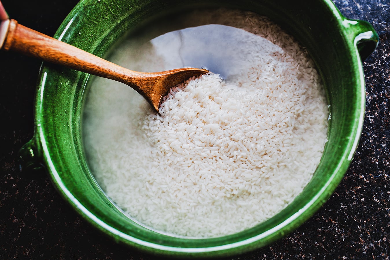 Soaking sticky rice in a green bowl.