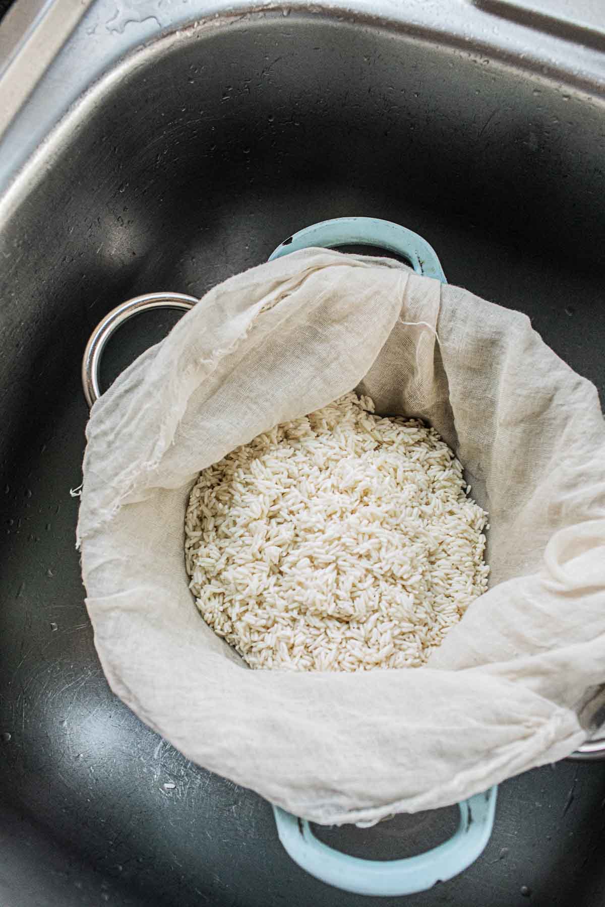 sticky rice in cheesecloth in s steamer. 