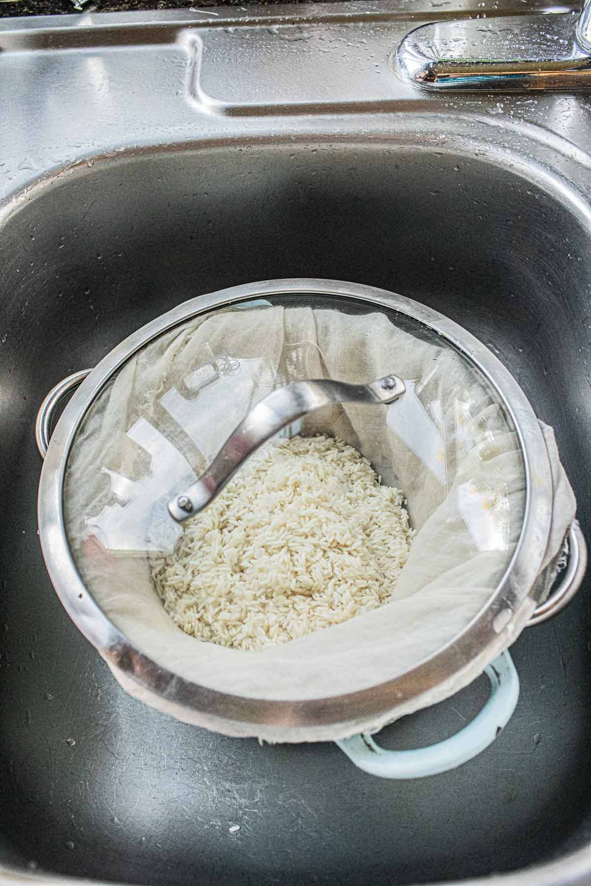 Sticky rice in cheesecloth in a dutch oven.