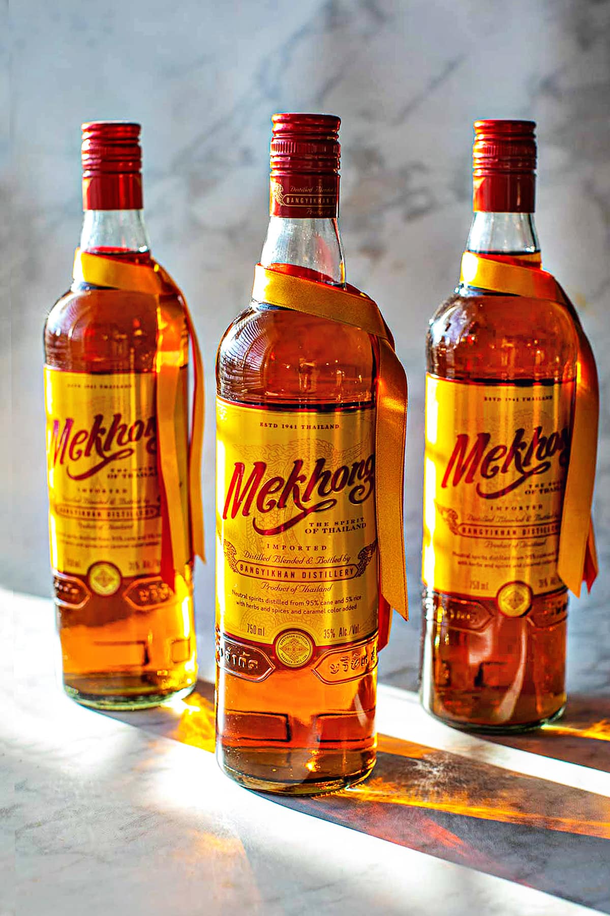 3 Mekhong Whiskey bottles on the table. 
