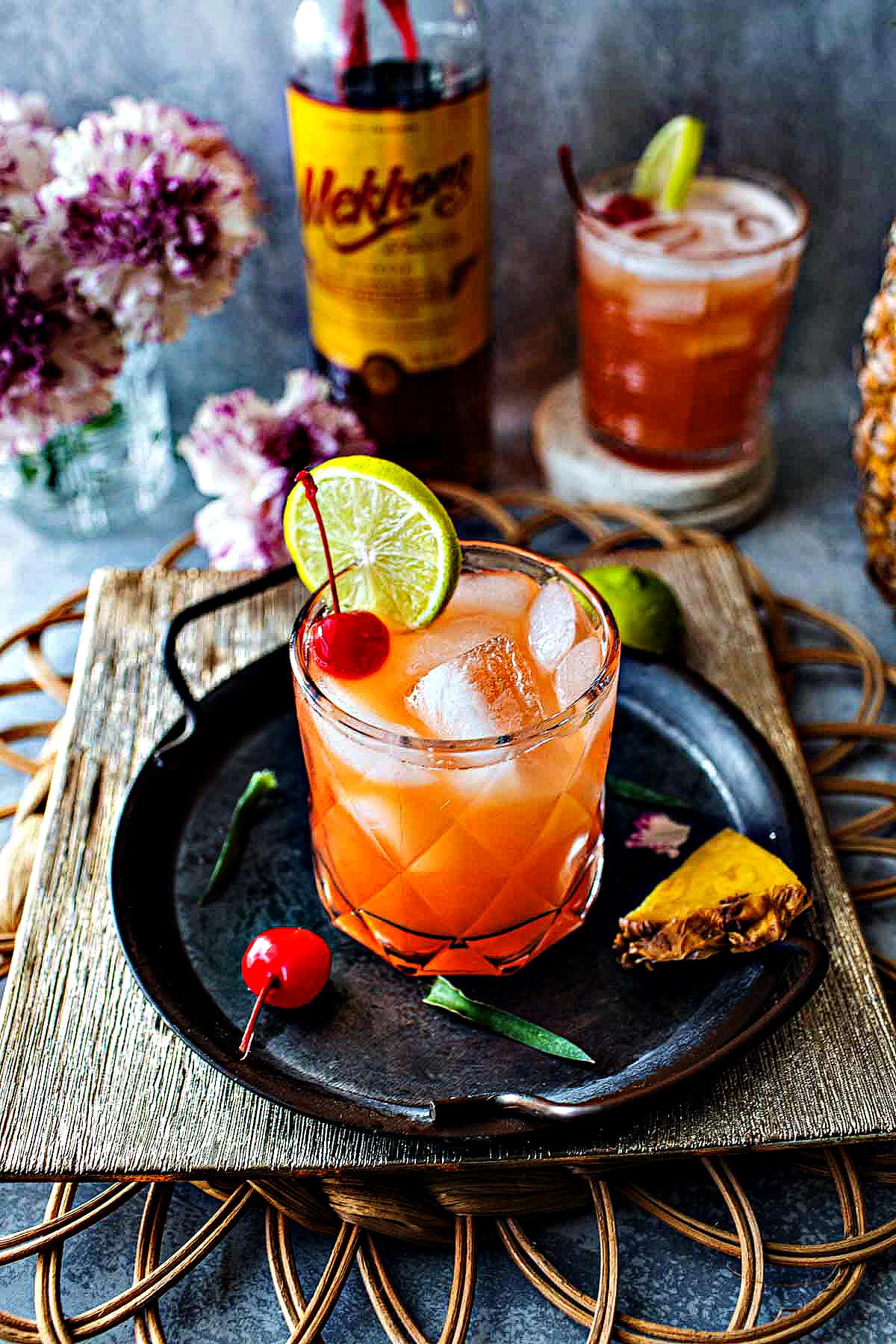 Mekhong whiskey sour with pineapple juice on a tray.