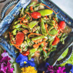 Thai green beans salad on a blue plate.