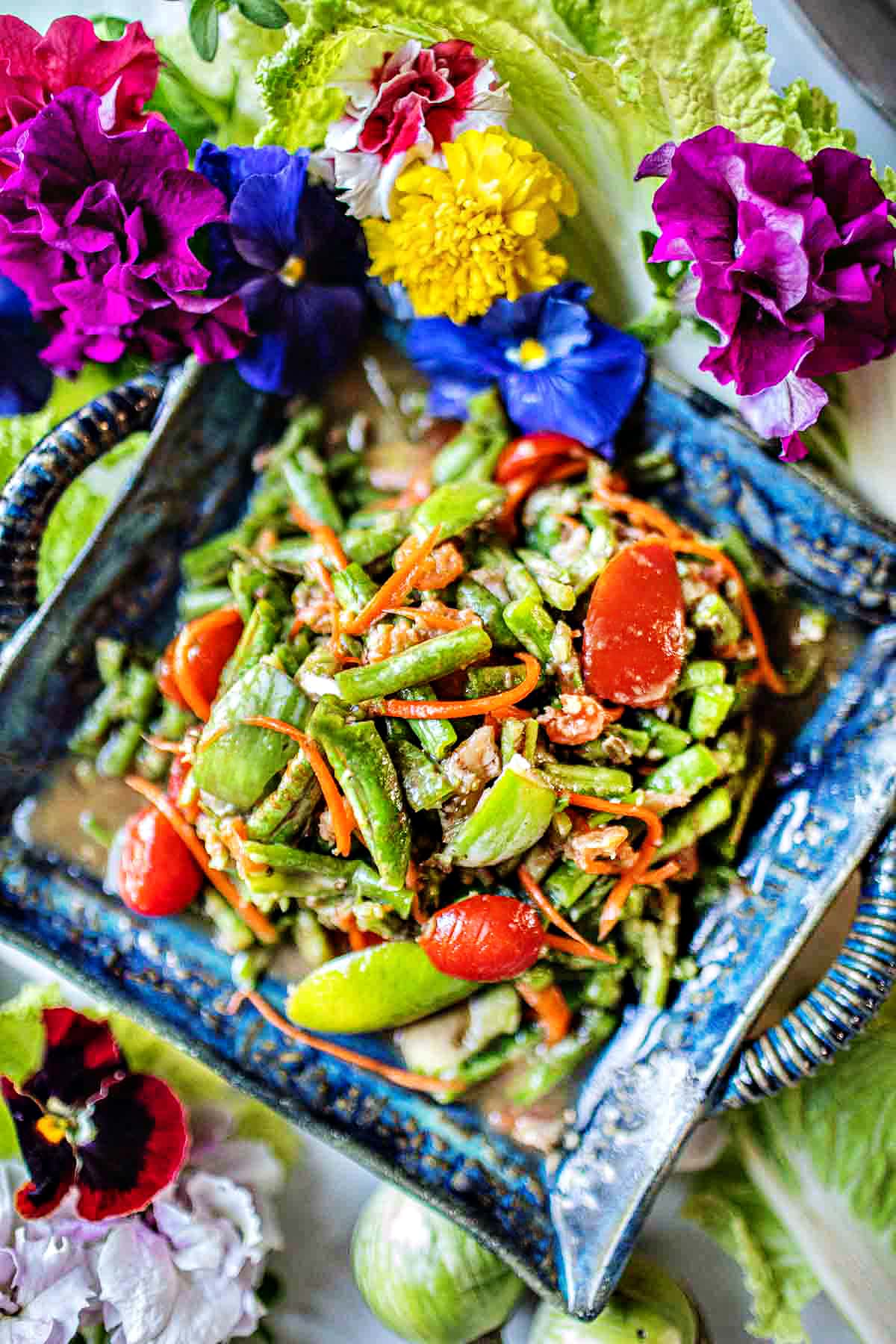 Thai green beans salad on a plate on the table.