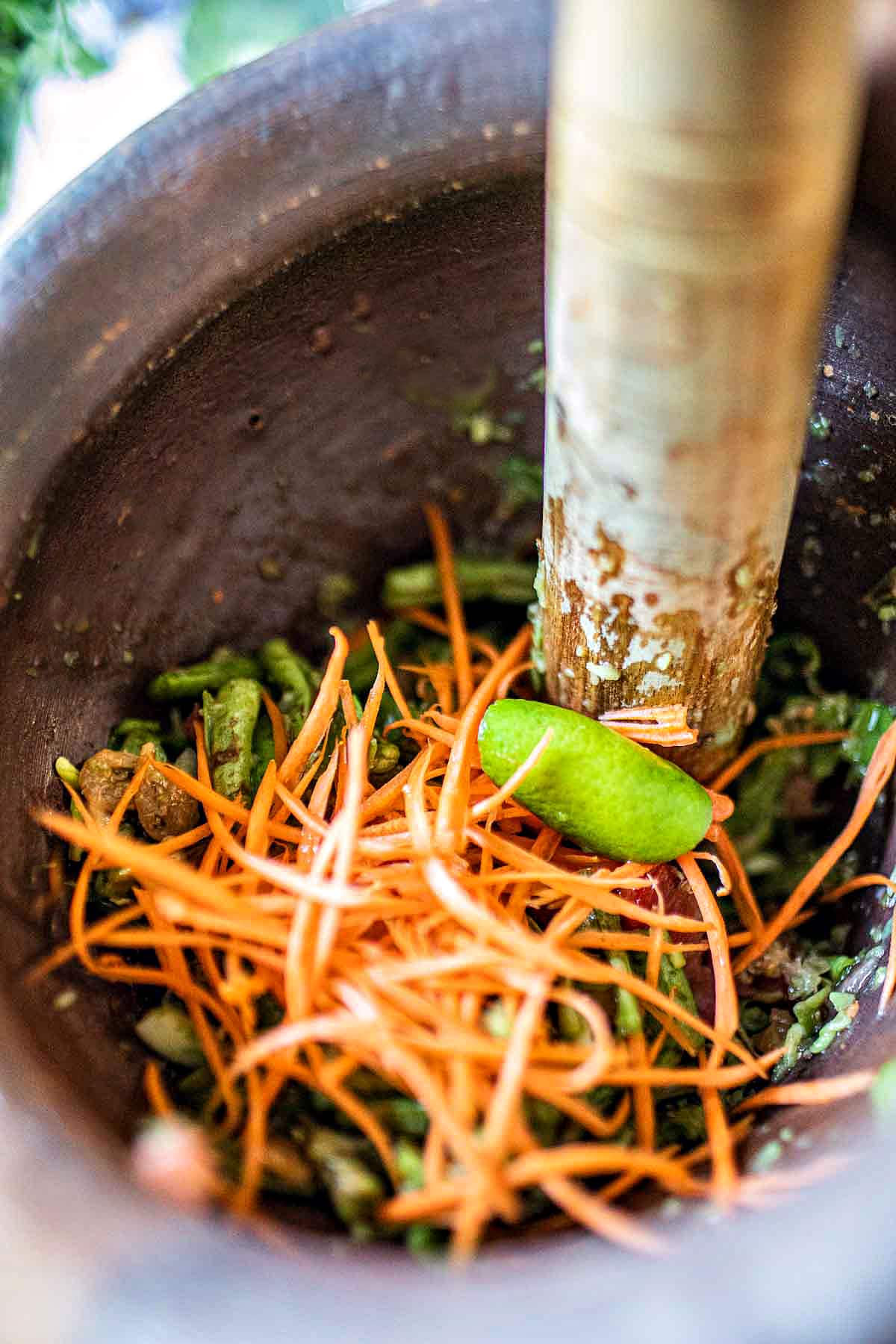 Shredded carrot in a mortar.