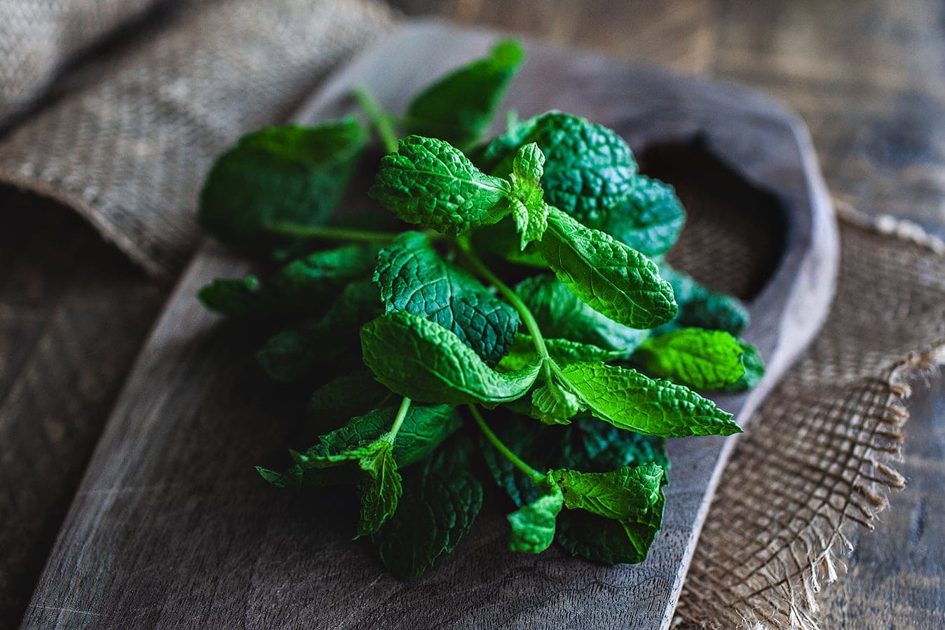 Mint leaves on cutting board.