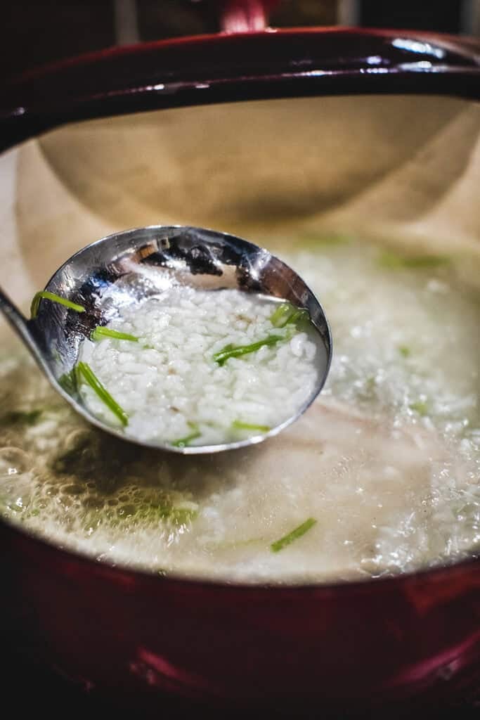 Spoon scooping rice from a pot.