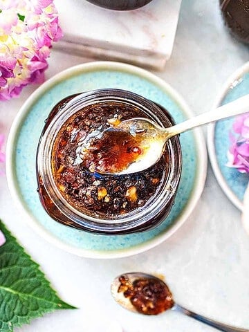 Pad thai sauce in a glass jar with a spoon.