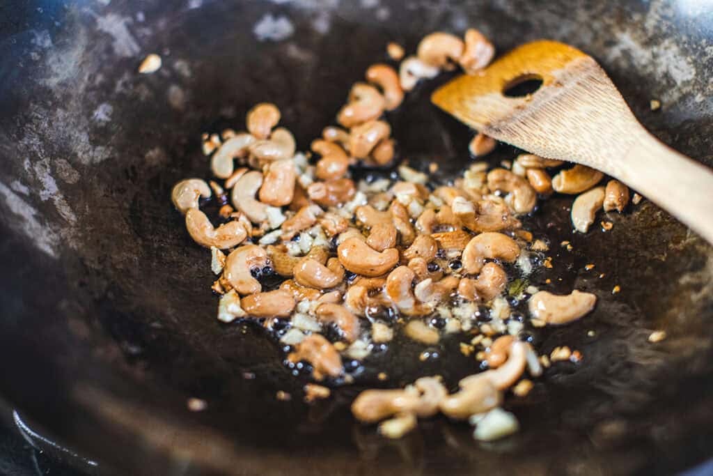 fried cashew in a wok. 