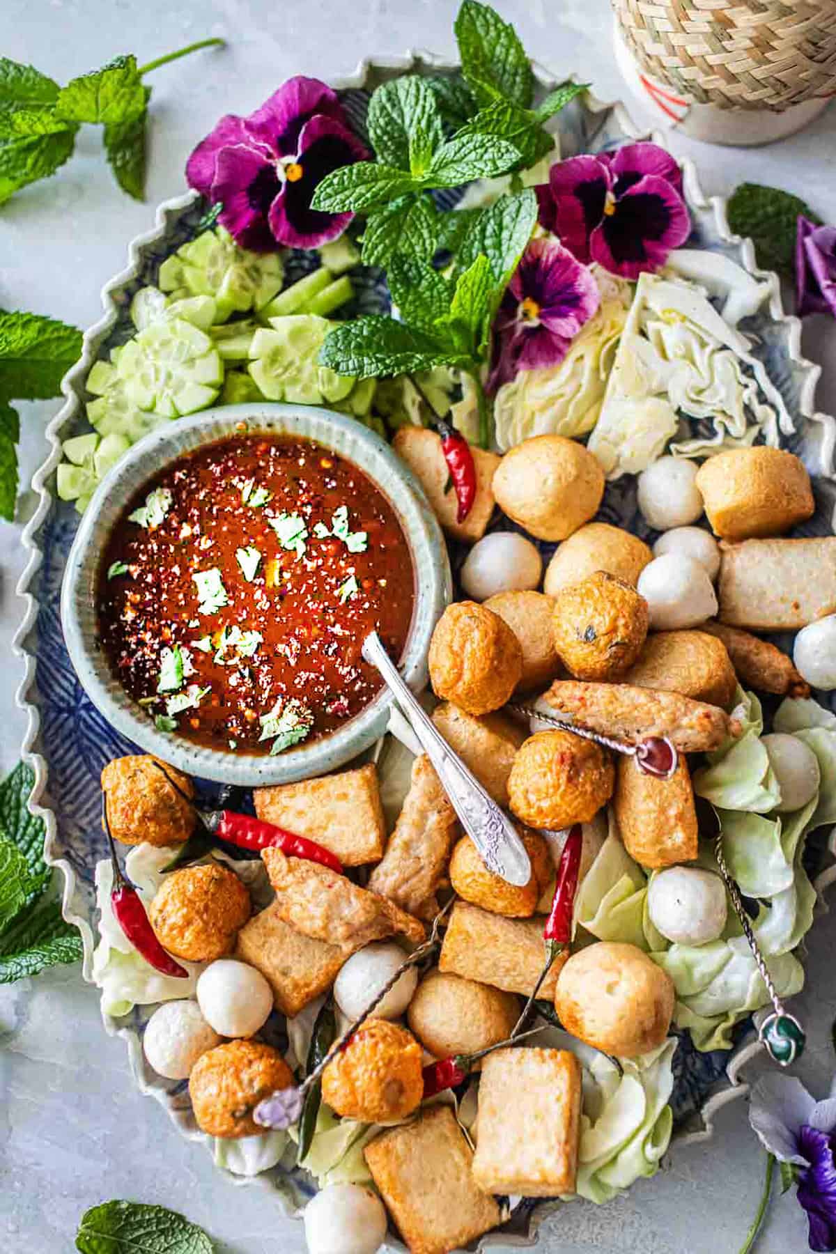 Tamarind dipping sauce in a bowl surrounded by meatballs.