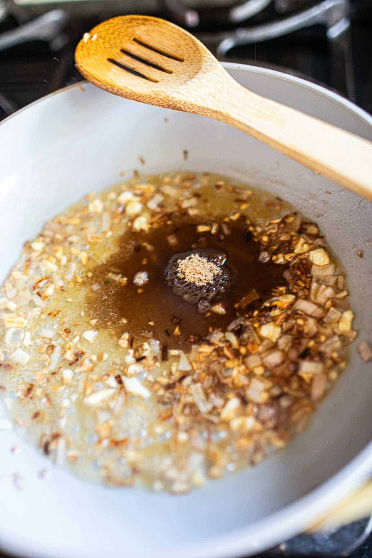 Sweet tamarind dipping sauce frying in a pan.