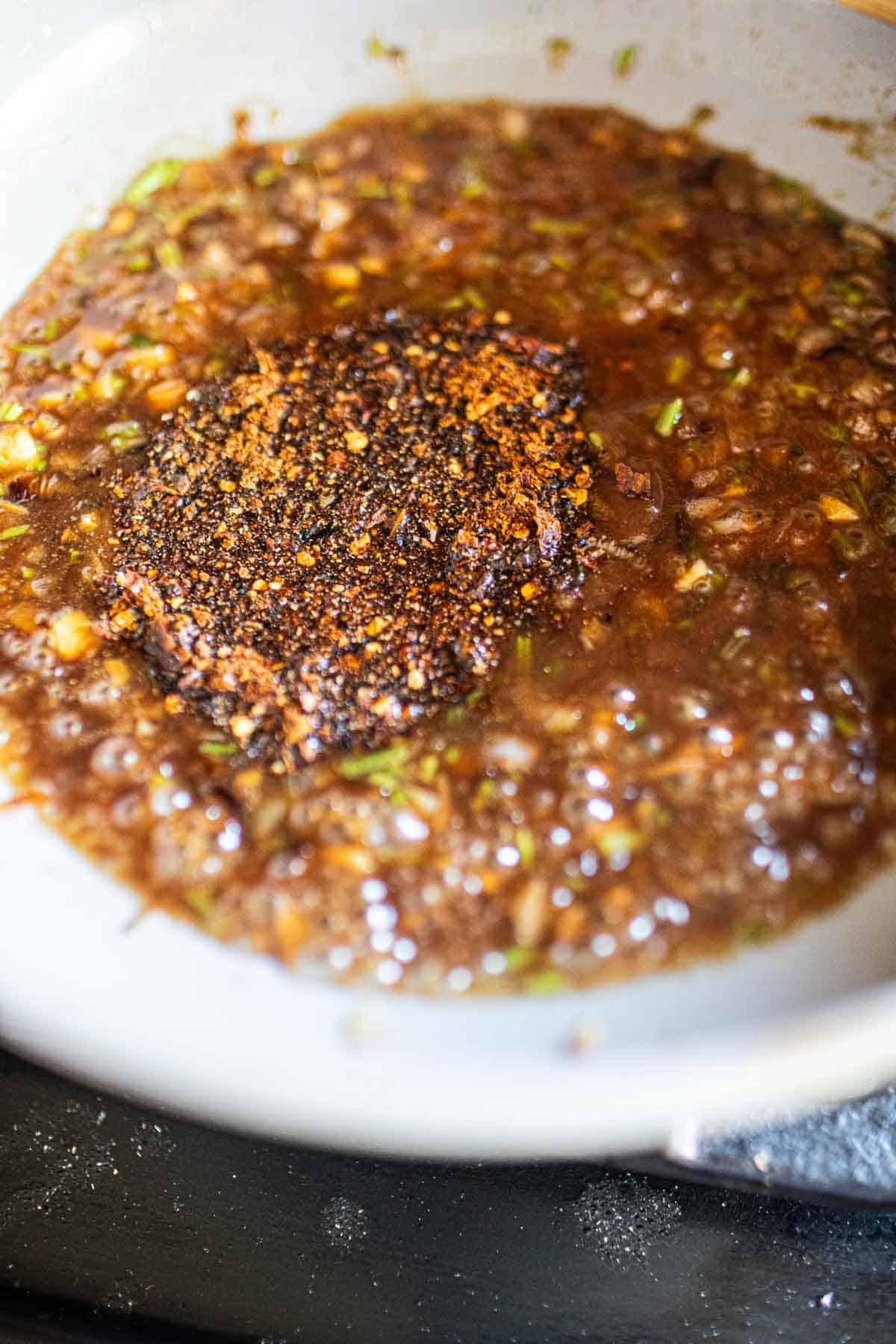 Chili flakes in a Thai tamarind dipping sauce in a pan. 