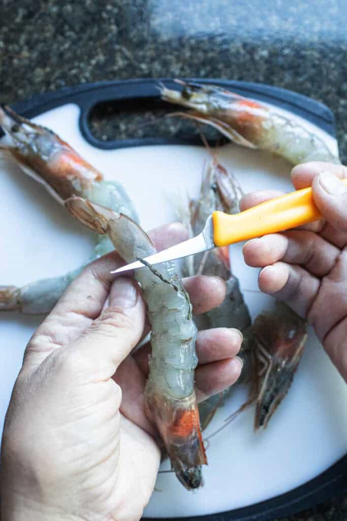 Deveining shrimp with a paring knife. 