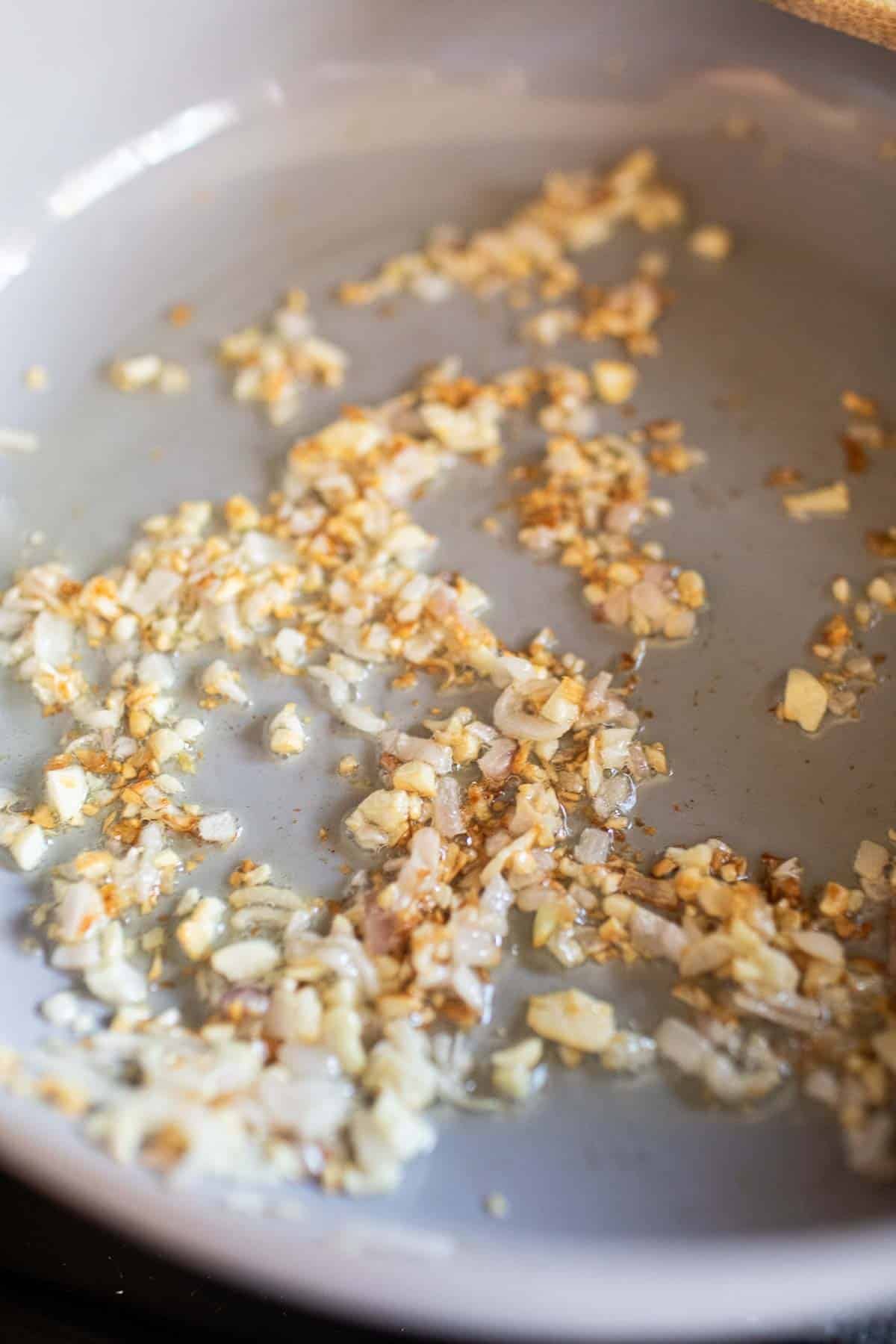 Garlic and shallot stirring in a pan. 