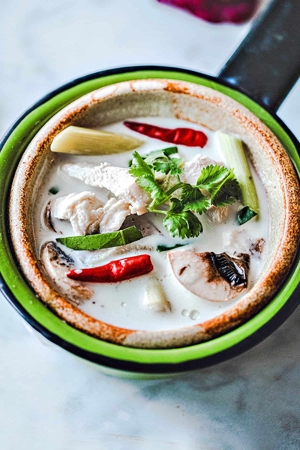 Thai chicken coconut soup in a bowl on the table. 