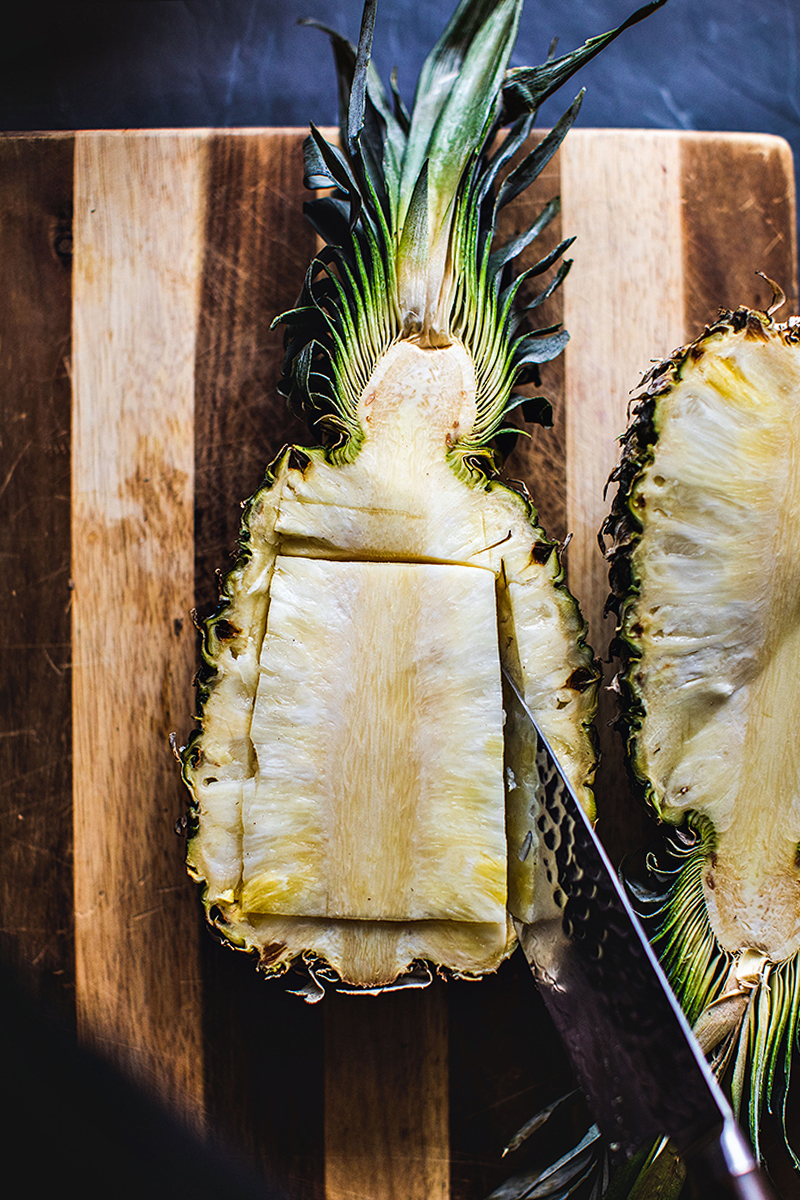 knife cutting pineapple flesh.