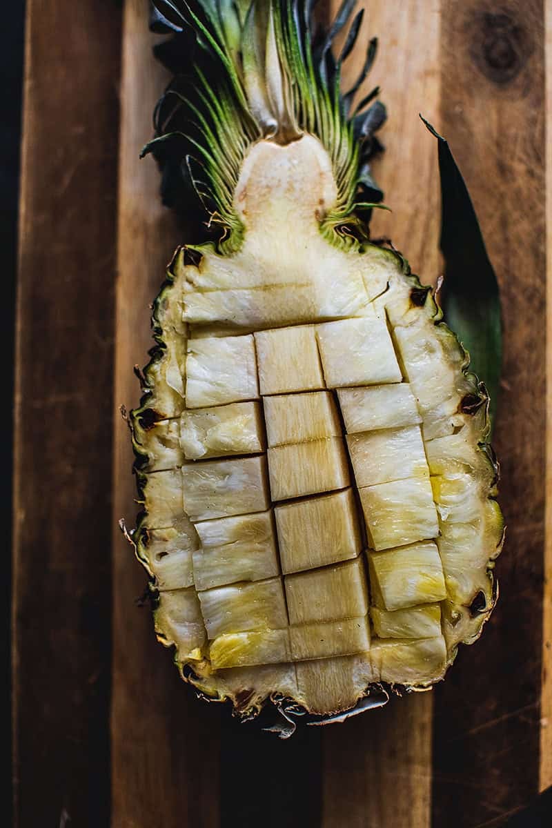 Pineapple cut into pieces inside a shell.